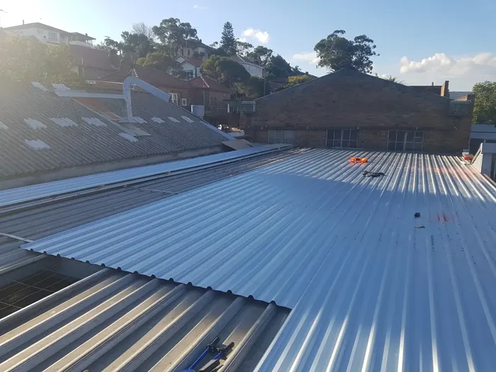 A newly sheeted metal roof beneath trees in Marrickville