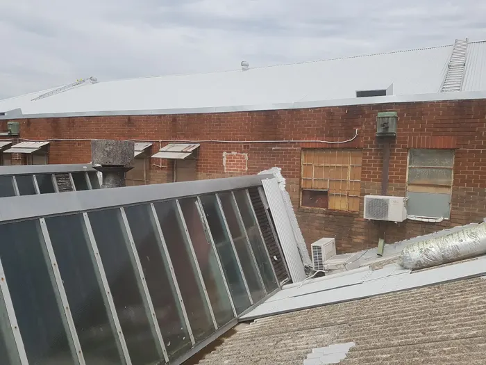 Several metal roof planes and a tall glazed roof structure in Sydney