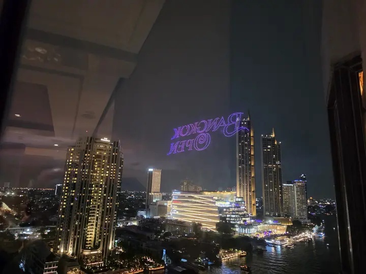 The Bangkok skyline at night with lit towers along the river
