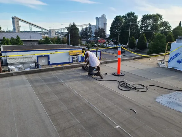A crew working across a broad flat roof.