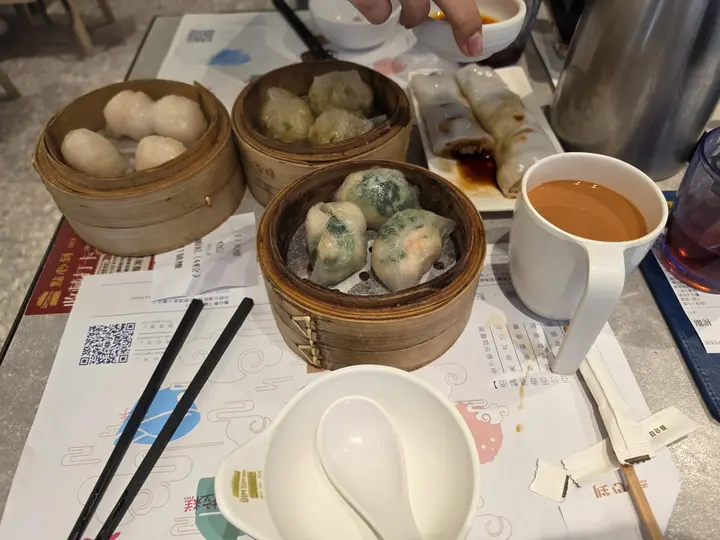 Steamer baskets of dim sum and tea on a table