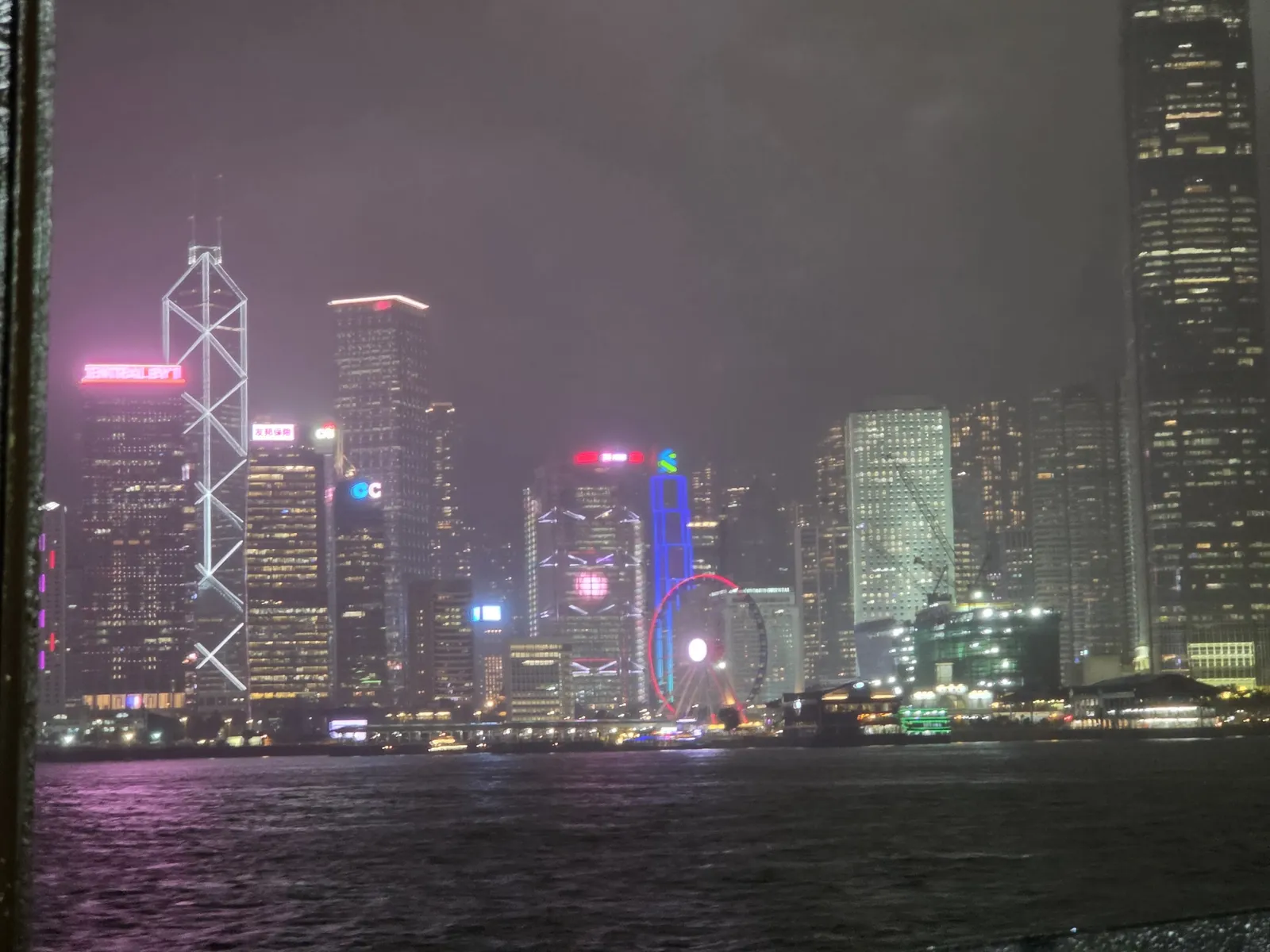 Hong Kong Island's skyline lit up across Victoria Harbour at night
