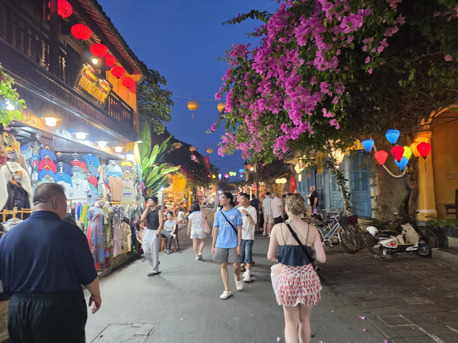 A Hoi An street at dusk strung with silk lanterns