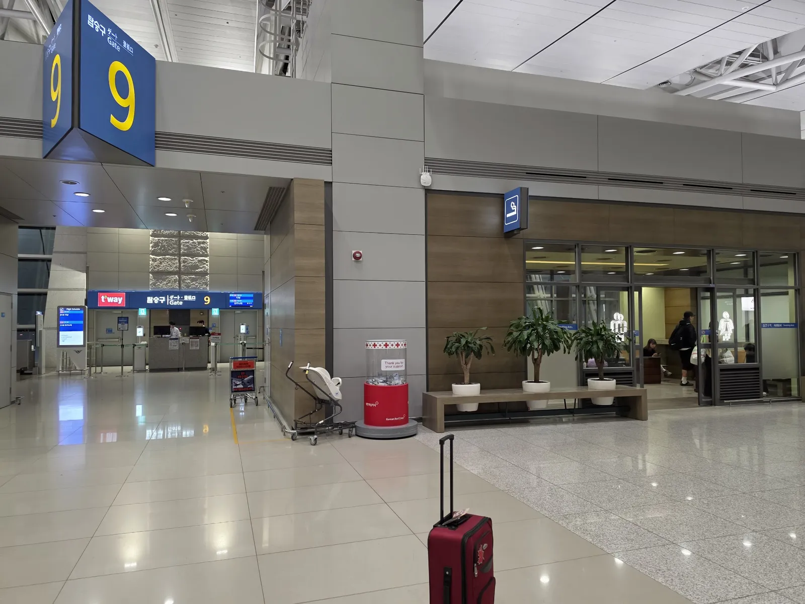 A quiet gate area at Incheon airport with a red suitcase