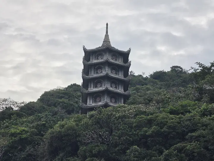 A seven-storey pagoda on a forested ridge of the Marble Mountains