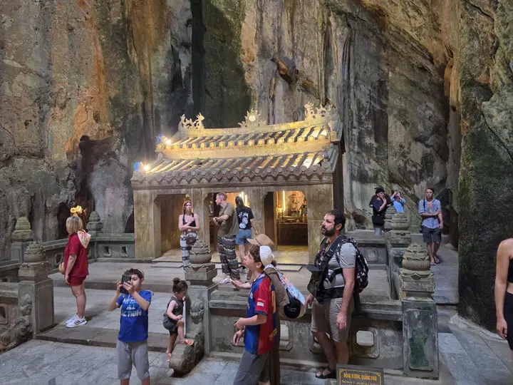 A shrine built into the back of a large limestone cave