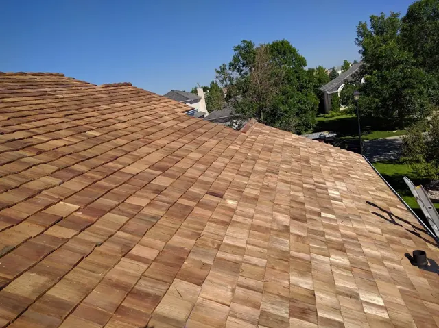 Cedar shakes across a residential roof, with courses following the roof valleys.
